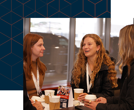 Three women engaged in conversation while enjoying coffee together